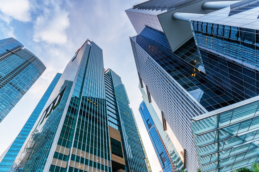 Standing in the middle of, and looking up at Highrise Buildings in a city